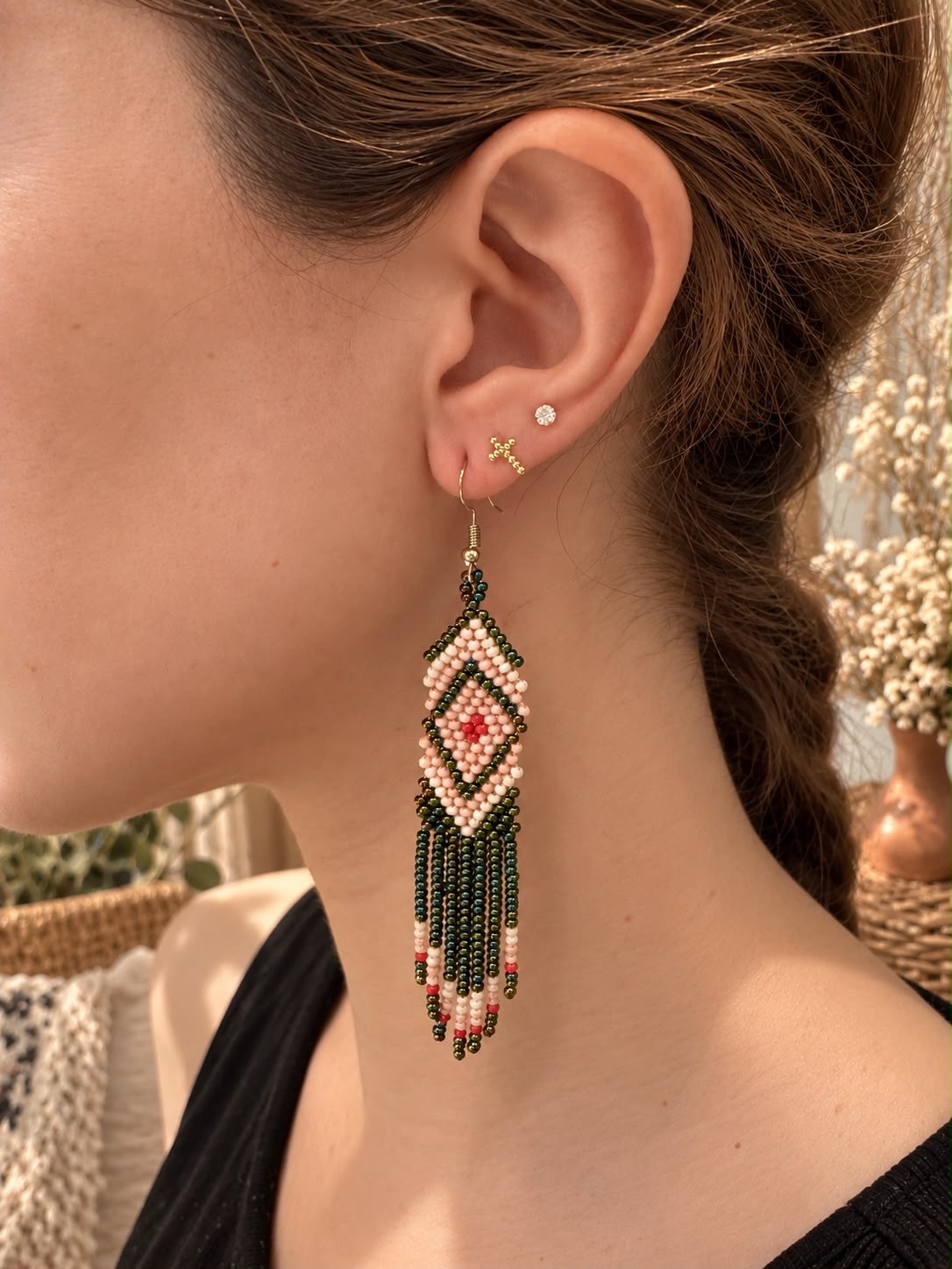 One long diamond-and-fringe beaded earring in pale pink, deep green and red
